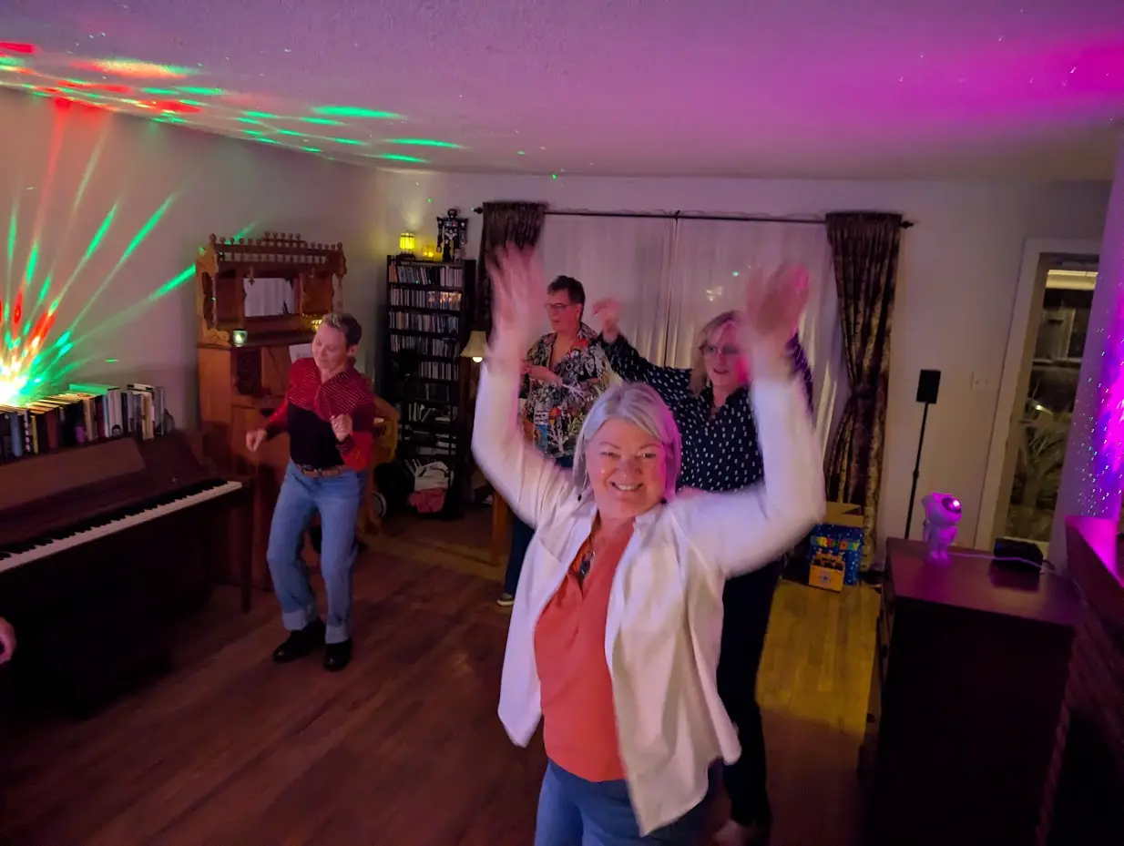 Julia showing some dance moves with guests and members at the after party dance.